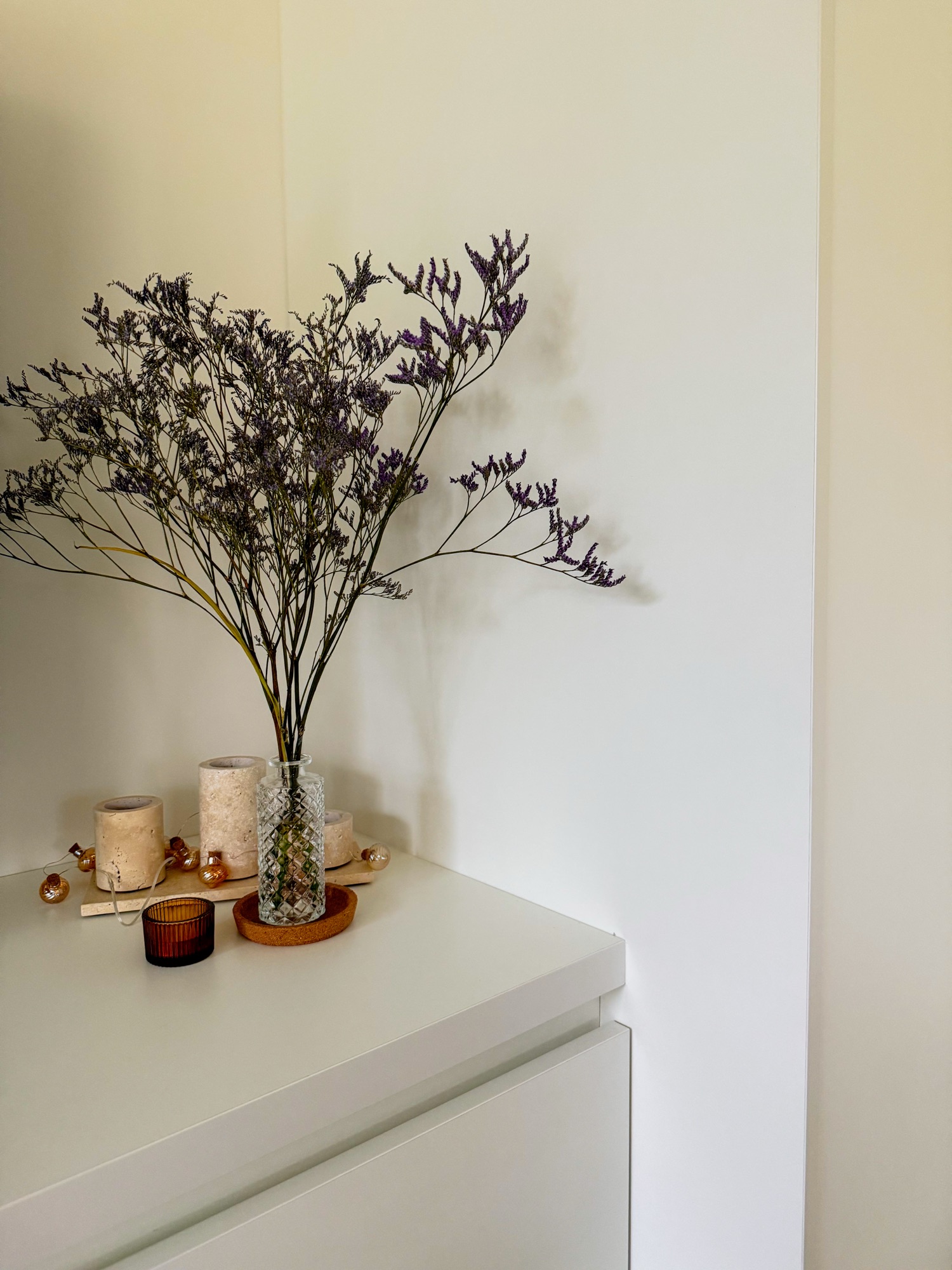 Minimalist home decor with dried flowers in a glass vase.