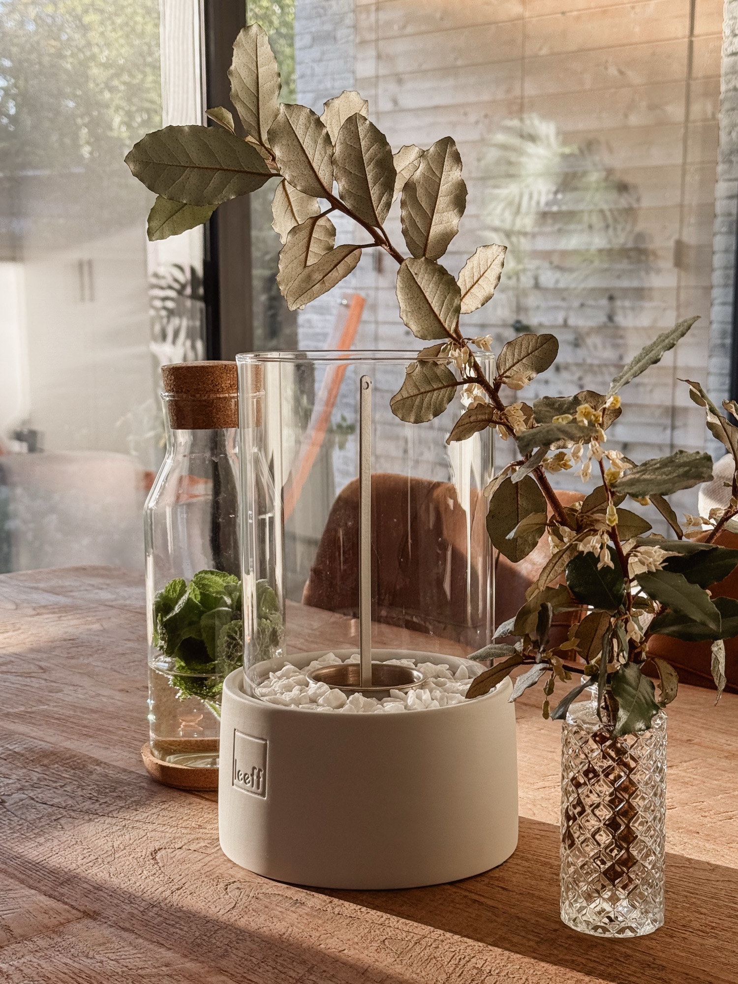 Leeff stonefire and elegant vase with dried foliage arrangement.