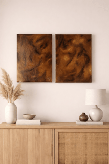 Textured abstract diptych in earthy tones styled above a wooden console in a warm neutral interior.